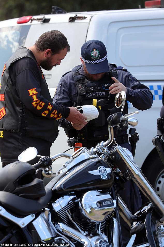 The Bandidos, swarmed by police, remained in good spirits as they were processed