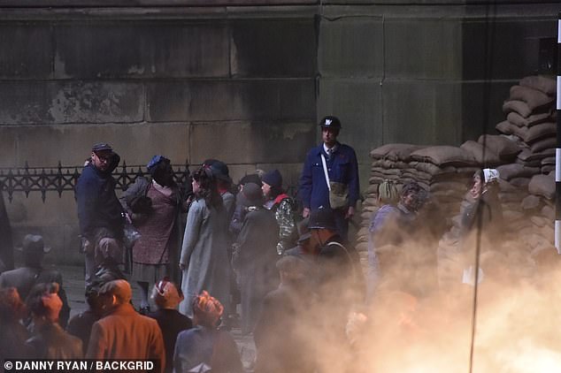 The cast was engulfed in smoke as they stood next to sandbags at the shelter