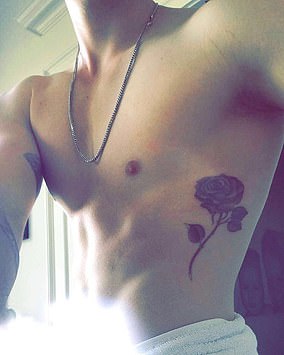 Artist Mark Mahoney inked a rose along his left ribcage