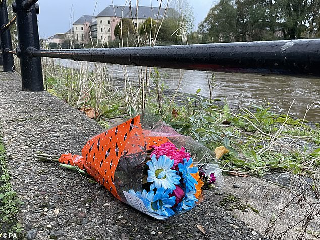 Flowers lay close to the scene on the River Cleddau, where the group died after falling into distress