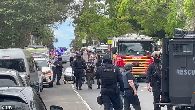 After the incident, the man is led away in handcuffs by the police