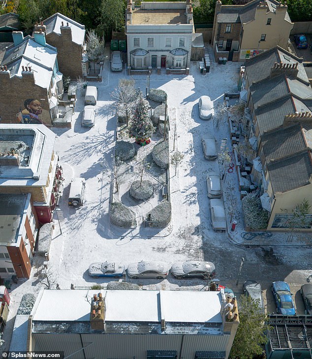 A large Christmas tree was placed in the middle of the snow-covered square and several red and gold Christmas boxes were placed underneath