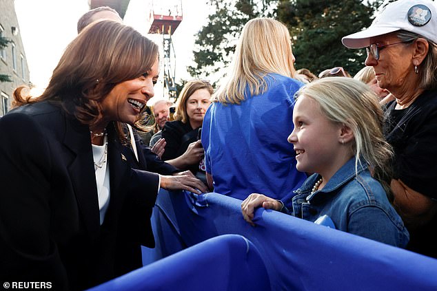 Kamala Harris speaks to a little girl during her rally in Ripon, Wisconsin on October 3, 2024