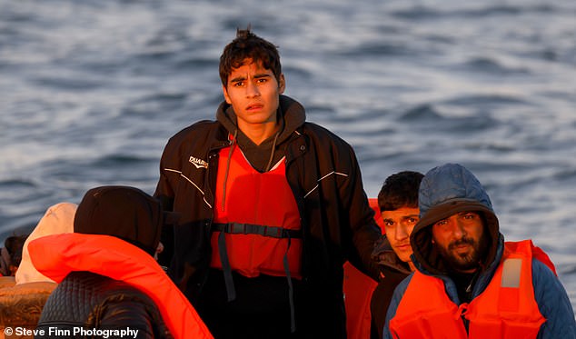 In the photo: Three men from the boat carrying a family of sixteen Iranian migrants, including two pregnant women