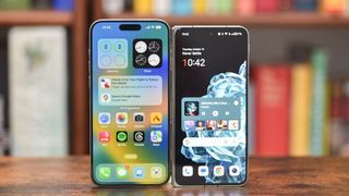 OnePlus Open standing next to an iPhone 15 Pro Max