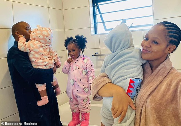 Basetsana (right) holds Blessing while her partner Gabriel (left) holds his twin sister Miracle. Their first daughter Adorable (center) stands between them