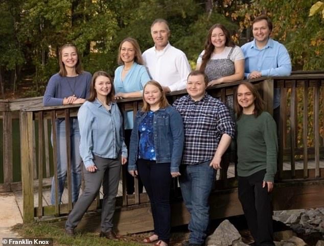 Mr. Stewart, pictured with his wife Jen and all seven children