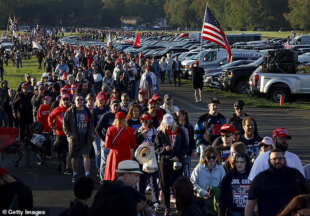 participants wait in line prior to a rally of Republican presidential candidate, former US President Donald Trump, at the Butler Farm Show Inc. on October 5, 2024 in Butler, Pennsylvania. Trump holds a rally in Butler at the site of his first assassination attempt