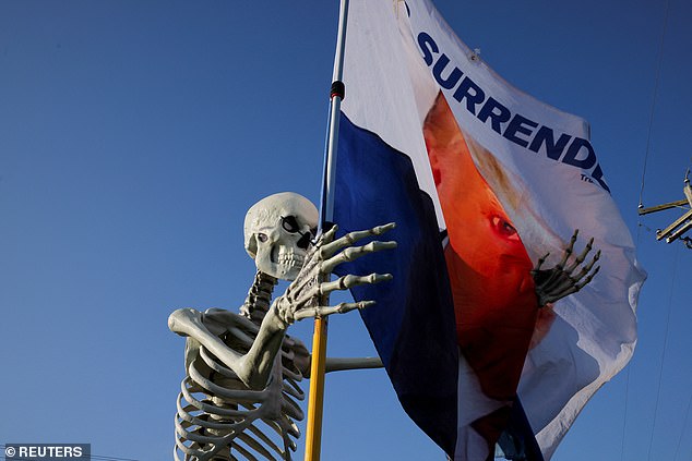 A Halloween decoration stands next to a flag in support of Republican presidential candidate, former US President Donald Trump, on the day Trump returns to the site of the July assassination attempt on him, in Butler, Pennsylvania, US, October 5, 202