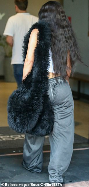 During her latest outing, she toted around a noticeably large, bulging black handbag covered in what appeared to be faux fur.