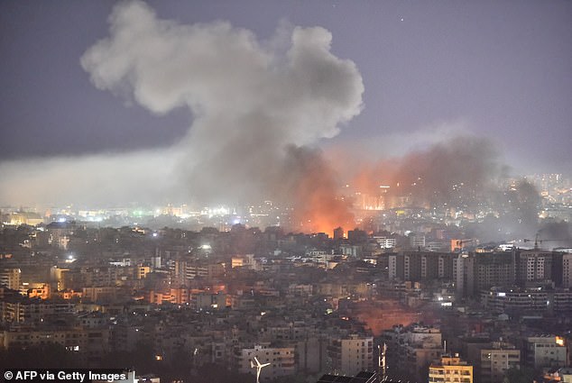 Smoke rises amid flames after an airstrike on a neighborhood in Beirut's southern suburbs