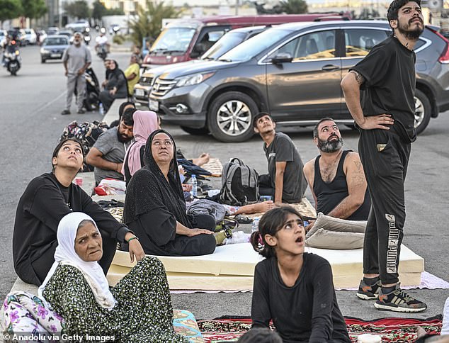 Displaced families bring mattresses in anticipation of having to sleep on the streets