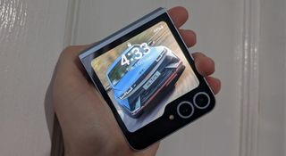 The Samsung Galaxy Z Flip 6 fully folded with a car background on the outer display