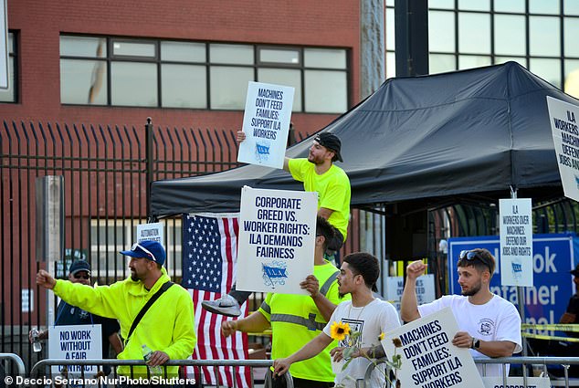 Port workers carry signs and demonstrate outside the Red Hook terminal in Brooklyn on Thursday