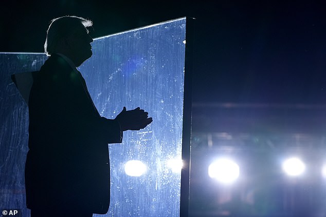 Republican presidential candidate, former President Donald Trump, listens as Christopher Macchio, not pictured, sings at the end of a campaign event at the Butler Farm Show, Saturday, October 5, 2024