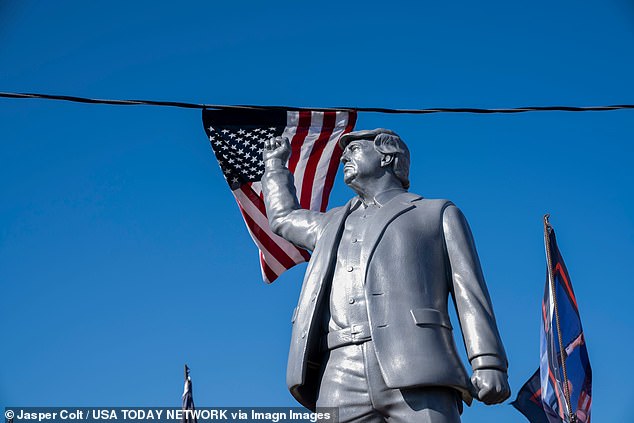 A statue of former President Donald Trump with his fist raised greets supporters before Trump speaks during a campaign rally in Butler, Pennsylvania, on October 5, 2024