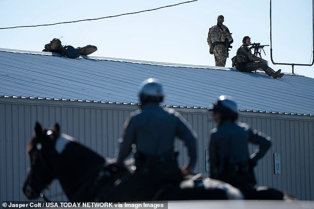 Secret Service snipers investigate from an elevated position before former President Donald Trump speaks at a campaign rally in Butler, Pennsylvania, on October 5, 2024