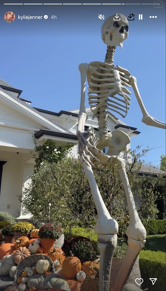 Jenner's adjacent mansion in Los Angeles was extravagantly decorated with a towering skeleton towering over her pumpkins and gourds