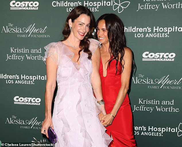 Meghan (pictured) enjoying chatting with her friend Kelly McKee at last night's event in downtown Los Angeles