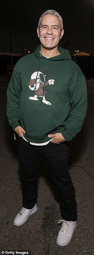 Andy Cohen wore a forest green Louis Vuitton sweatshirt and black pants