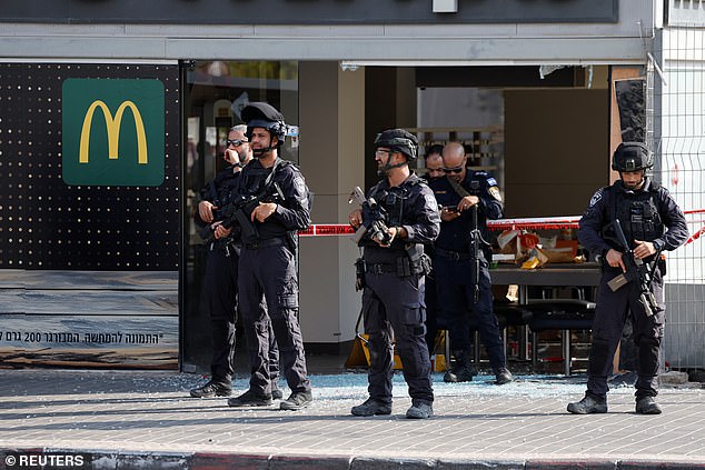 Israeli police work at the scene of an attack in Beersheba, southern Israel, October 6