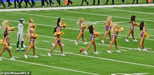 The cheerleaders formed two lines around the Jets kicker and continued to perform