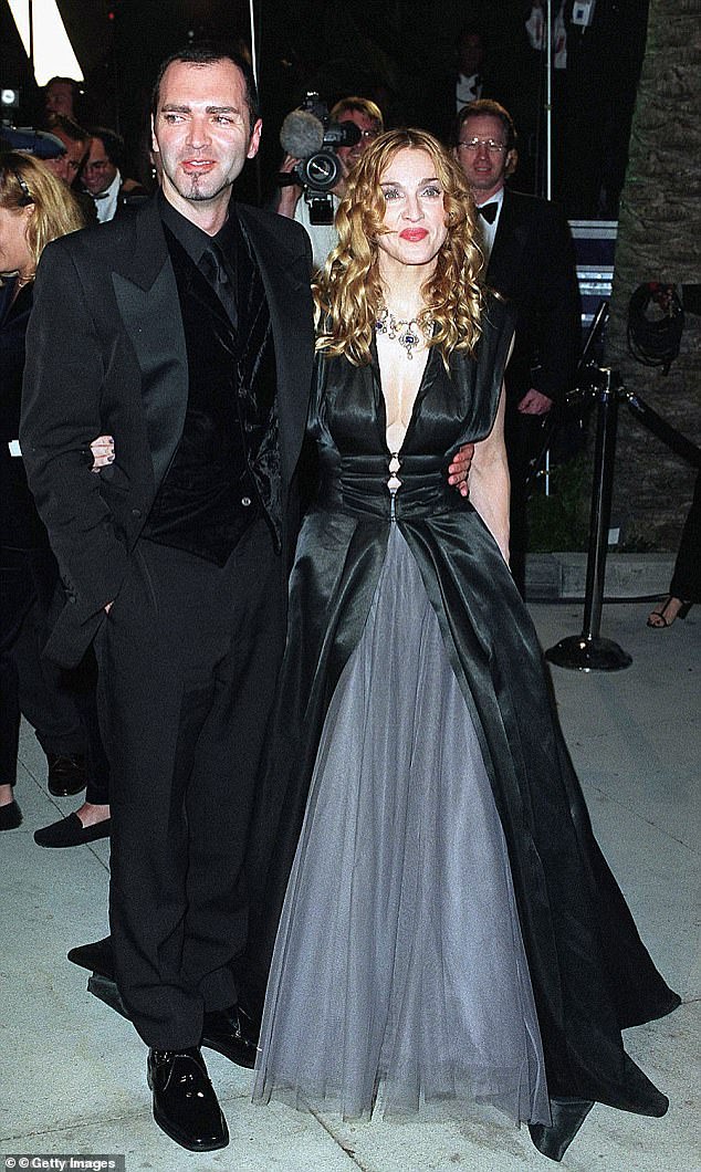 The two worked closely together during the Queen of Pop's career, but fell out when he published a bombshell book about her (pictured at the Vanity Fair Oscar Party in 1998).