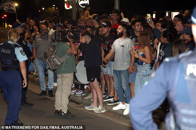 Two police officers are pictured observing the festivities in Penrith