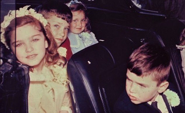 Madonna goes to her First Communion in 1967 with her siblings Marty, Melanie and Christopher leading the way