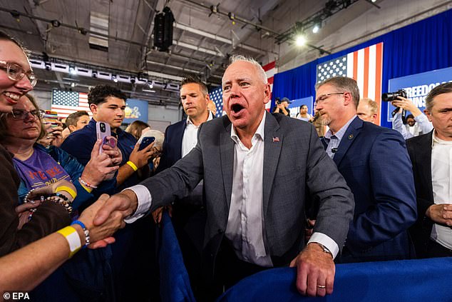 Minnesota Governor and Democratic vice presidential candidate Tim Walz (C) greets supporters at a campaign rally,