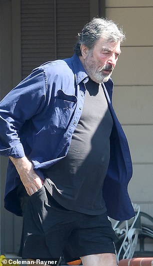 Exclusive photos from DailyMail.com show Selleck dressed in a blue button-down shirt, black T-shirt, shorts and sneakers, and carrying a folder full of papers