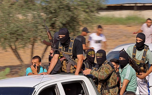 Palestinian Islamic Jihad terrorists are seen heading to cross the Israel-Gaza border fence from Khan Younis during the October 7 Hamas-led attack