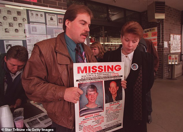 Mullenberg's mother Monica and stepfather Jake Bourget hold up the missing person sign after Jessyca was kidnapped by a neighbor in Eau Claire, Wisconsin