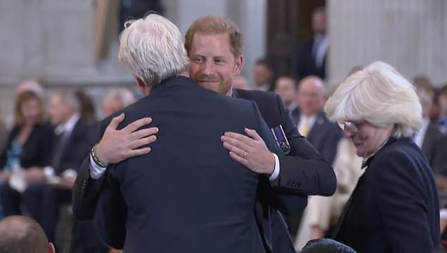 Prince Harry hugs his uncle, Charles Earl Spencer, as his aunt Lady Jane Fellowes stands nearby during the 10th anniversary of the Invictus Games in May