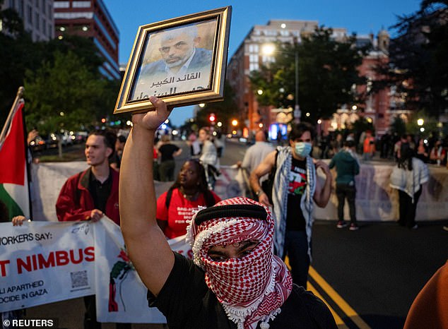 A pro-Palestinian protester holds a photo of Hamas leader Yahya Sinwar during a march ahead of the anniversary of the October 7 attack near the White House in Washington