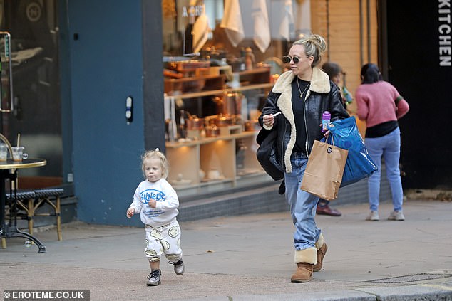 To complete her fall look, the personal trainer pulled her hair into a bun and shielded her eyes with sunglasses