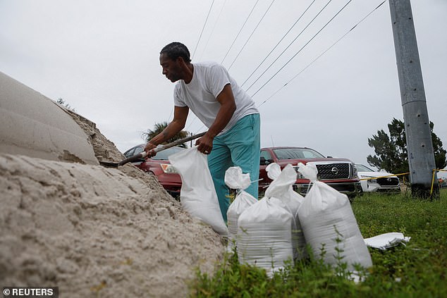 Lenard Cox prepares sandbags to be distributed to Pinellas County residents ahead of Tropical Storm Milton's expected arrival in Seminole, Florida, on Sunday