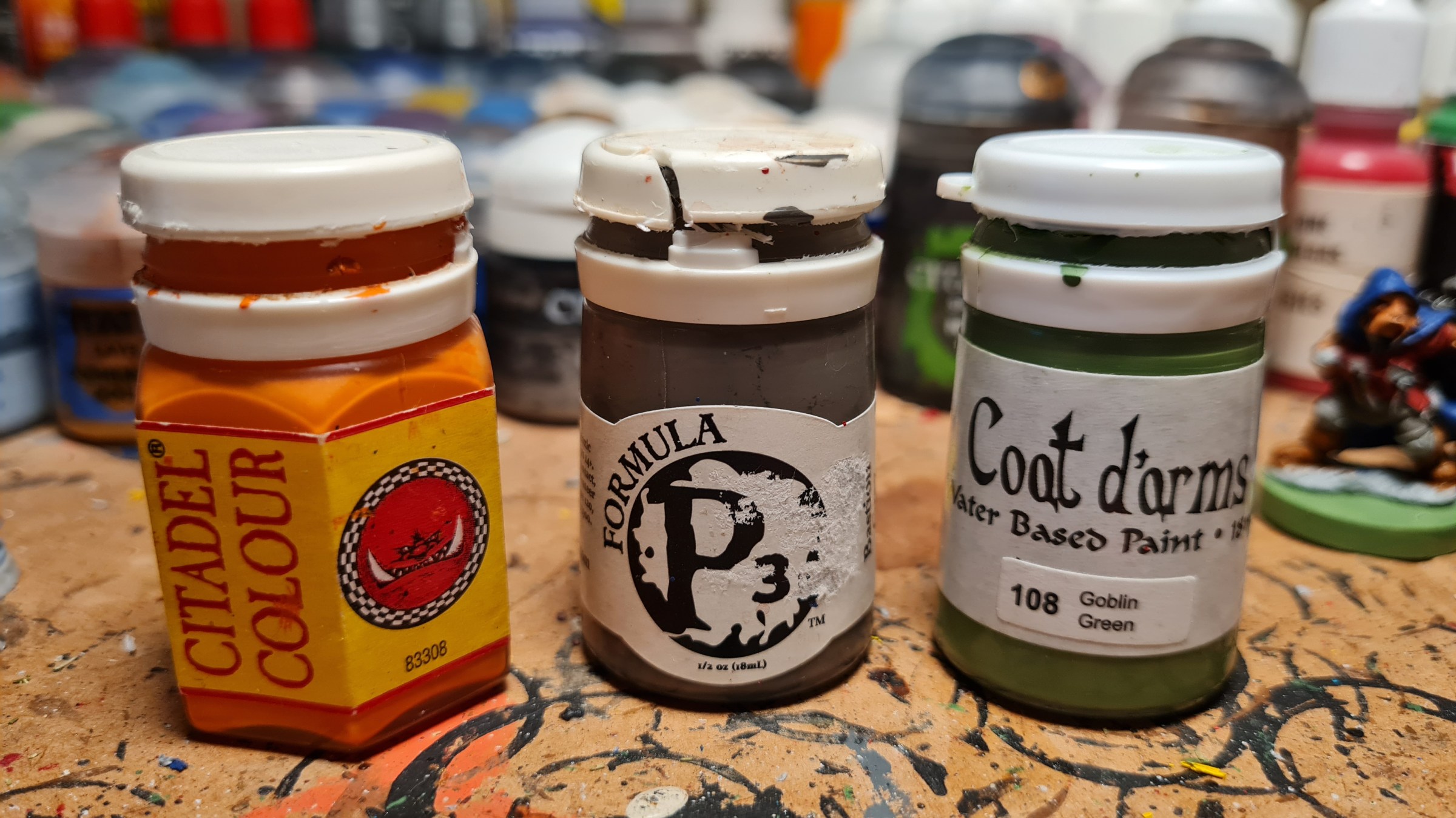 From left to right: 1994 Citadel Color paint from Games Workshop, Formula P3 from Privateer Press and Coat d'Arms paint. All three lines are or were manufactured by the British HMG Paints and have their characteristic sturdy pots with white plastic lids.