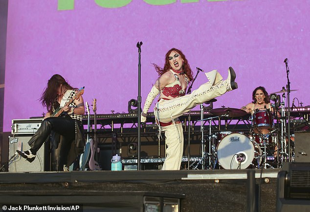 The singer stomped around the colorfully lit stage in a pair of white boots and let her wild mane of bouncy red curls flow down her back