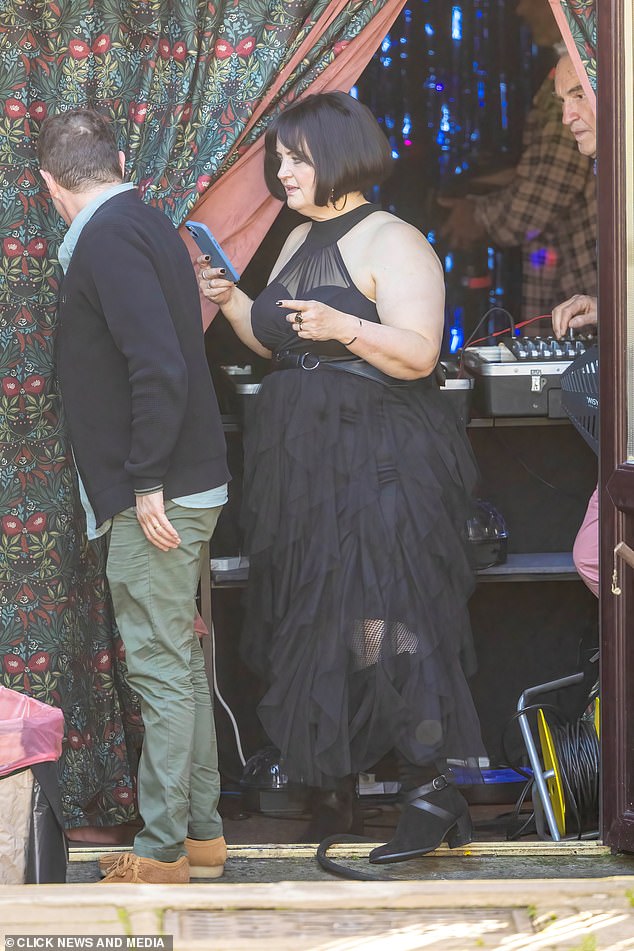 Nessa was dressed in a flowing black dress - an appropriate bridal gown for her goth style - which she paired with knee-high boots and fishnet tights