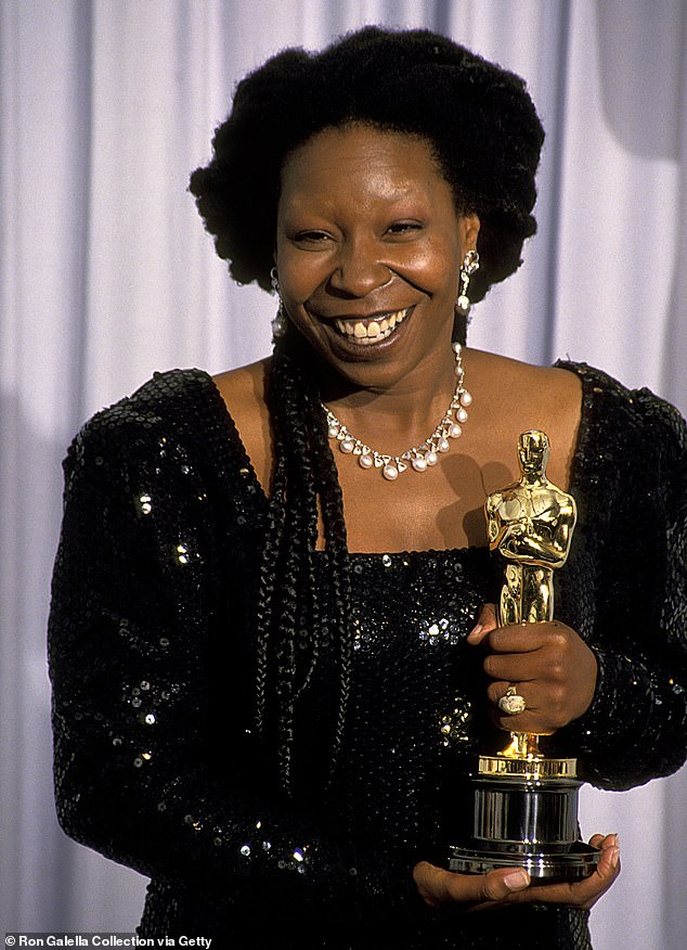 Whoopi poses with her Oscar statuette for Best Supporting Actress at the 1991 Academy Awards