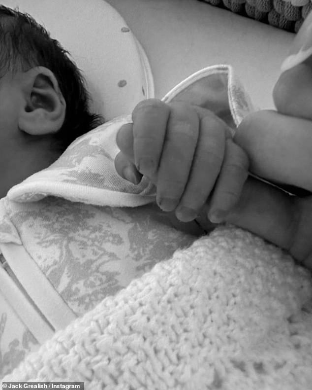 The Manchester City footballer shared an adorable black and white photo of his newborn little girl holding his finger