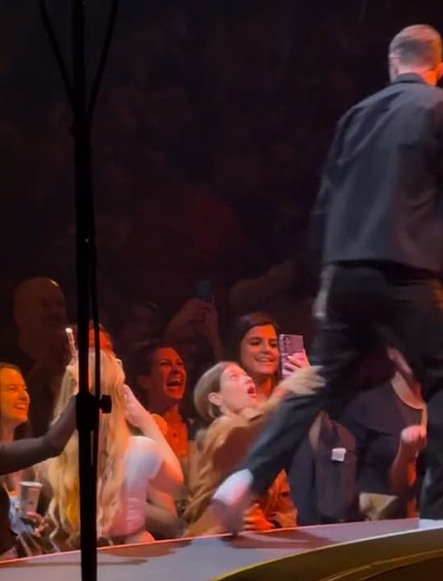 The young woman desperately reached out to grab Timberlake, but it was too late