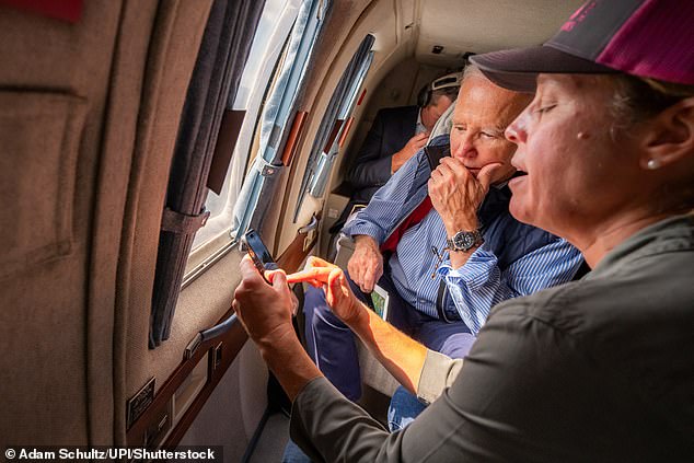 President Joe Biden speaks with Mayor Esther Manheimer of Asheville, North Carolina during an aerial tour aboard Marine One to assess areas affected by Hurricane Helene, Wednesday, Oct. 2, 2024, in western North Carolina. Such flights, Mills said, caused other aircraft conducting relief work to be grounded, interrupting their critical operations