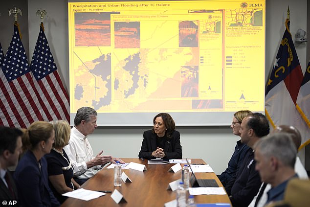 Democratic presidential candidate Vice President Kamala Harris, center right, receives a briefing from North Carolina Governor Roy Cooper, center left, on damage from Hurricane Helene, Saturday, October 5, 2024 in Charlotte, NC