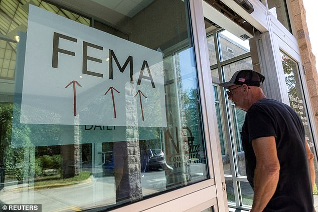 A resident enters a makeshift FEMA station to attend claims from local residents affected by flooding after Hurricane Helene in Marion, North Carolina on October 5, 2024