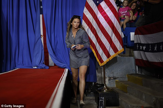 Margo Martin, deputy communications director for the Trump campaign, walks past the stage in Juneau, Wisconsin