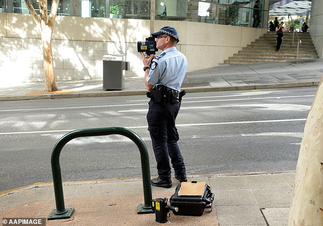 A task force found a French driver had racked up 1,606 points on NSW roads in three months - enough to lose his license 123 times (pictured, a police officer uses a speed radar)