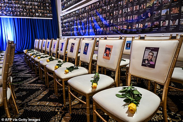 Before the commemoration, empty chairs with flowers and photos of victims of the Hamas attack on Israel can be seen