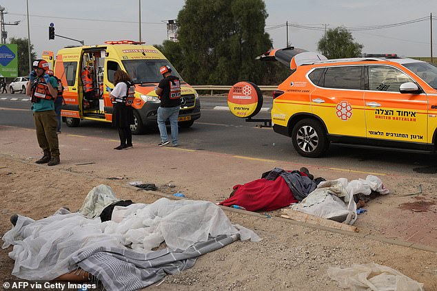 The bodies of civilians killed in a Palestinian militant attack lie covered in the southern Israeli city of Sderot on October 7, 2023